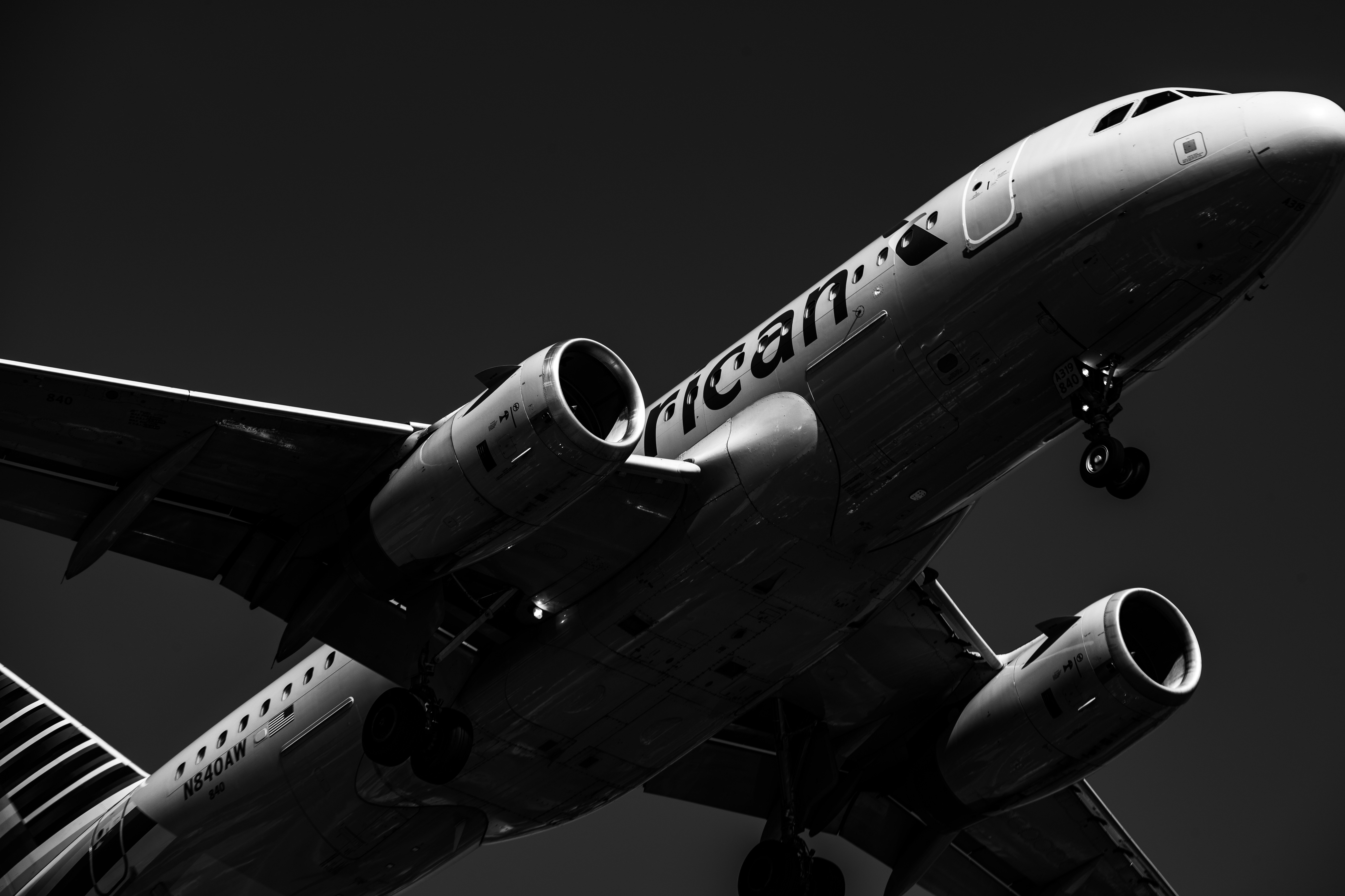 grayscale photo of white and black airliner